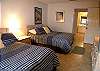 Second bedroom with 2 double beds, cable TV & adjoining bath with tub/shower.