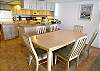 Large dining table with 6 chairs and 2 stools at the counter.