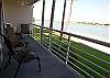 Large bayfront balcony spans the width of the living room and master bedroom.