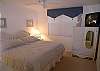 Guest bedroom with king bedding (twin mattresses), cable TV and adjacent bath with shower.