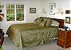 Queen bed in the lower master bedroom. A door in this room opens onto the lower deck.