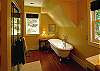 The main level of the home sports a wonderfully comfortable bathroom with claw foot soaking tub as well as walk in shower.