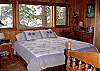 The master bedroom at Karemar Cove offers a king size bed, view of Mount Baker and private bathroom.