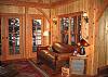 The front hall opens to a fireside alcove with 2 story cathedral ceiling and water view. French doors open to the patio.