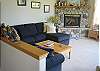The highlight of the large sunken living room is this impressive river rock propane fireplace. The sofa, pictured on the left, folds out into a comfortable sleeper to provide an extra sleeping area.