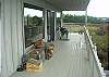 Tranquil Cove Hideaway has an expansive waterside deck across the upper level.