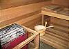 The cedar sauna is located on the lower level, across from the entertainment area, and next to the third bathroom.