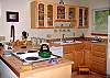 The cook will enjoy this pretty, well equipped kitchen.