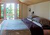 The master bedroom is on the upper level and enjoys views of Upright Channel. Features king-size bed and balcony.