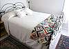 A smaller second bedroom offers an antique double bed.