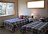 The third bedroom, also on the upper level, features two twin beds.