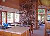 Looking from the kitchen toward the dining area and beyond to the living room. Both rooms open to a wrap-around deck.