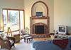 A lovely open hearth fireplace and TV in the great room.