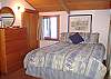 Queen bed in the loft. Partition separates the sleeping space from the twin beds.