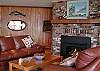 The living room has a gas fireplace and view of the water.