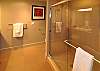 Huge bathrooms & shower. You'll note the vanity and large mirror reflected in shower door.