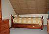 The loft bedroom offers a single bed and large single futon, as well as a TV and VCR.