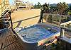 The hot tub is located off the guest bedroom on a lower deck.