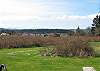 As you exit the kitchen, the view takes in meadows, peek of the water to southern Lopez & the Olympics.