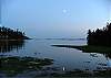 The moon is reflected in the still waters of Buck Bay.