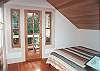 Quiet upper level bedroom has small balcony with territorial views.