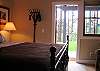 Bedroom has access to the patio and lawn.