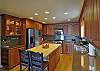 This beautifully upgraded kitchen has high end appliances and a work island.