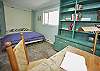 The bedroom features a queen sized Murphy bed and desk.