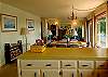 Upper open living area includes kitchen, dining, and fireplace.