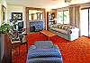 lower level has wood stove, TV, piano, and pool table.