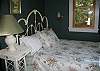 This quiet bedroom faces the gardens.