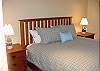 This queen bed is on the lower level with a bathroom in the hall. There is also a mini-kitchen and seating area downstairs.