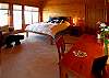 The romantic master suite bedroom offers a king sized bed, TV, and fireplace.