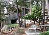 Waterside deck with chairs and picnic table.