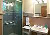 Bathroom just down the hall from bedroom on the main level has tiled shower.