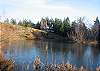 Main House, high on the rocky knoll, pictured from across Boss Lake.