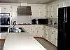 Well-stocked kitchen has double ovens, large island, and all the conveniences.