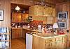 The kitchen at Karemar Cove has a modern range, as well as old fashioned woodstove-cookstove.