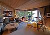 The cozy great room perches over the water.