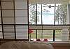 The loft looks over the Strait. Shoji screens slide across the railing for visual privacy from below.