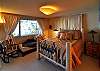 The master bedroom has a queen size bed &amp; daybed by the window. You can step out the door to the deck &amp; swing.