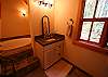 The master suite vanity with romantic tub in an alcove. A stall shower tiled in slate is on the opposing wall.