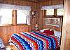 The bright and eclectic back bedroom offers a comfortable double bed and TV with DVD.