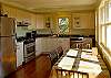 Modern stainless steel  appliances and wonderful views highlight this centrally located  kitchen which also offers easy access to both the deck, living area and the upper level master bedroom.