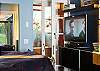 In the evening , you can lounge in silken comfort to watch a DVD on the large screen TV in the bedroom.