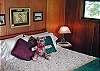 Another guest room with queen bed and a door to a private deck with views of Obstruction Island.