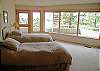 The third bedroom contains two twin beds and private bath, and opens to the deck and hot tub.