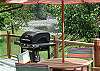 A BBQ and dining table on the deck.
