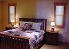 This queen bed is on the main level and opens to a bathroom that doubles as a powder room.