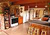 The kitchen of this old farmhouse is open and modern and has a view of the dahlia garden and Buck Bay.